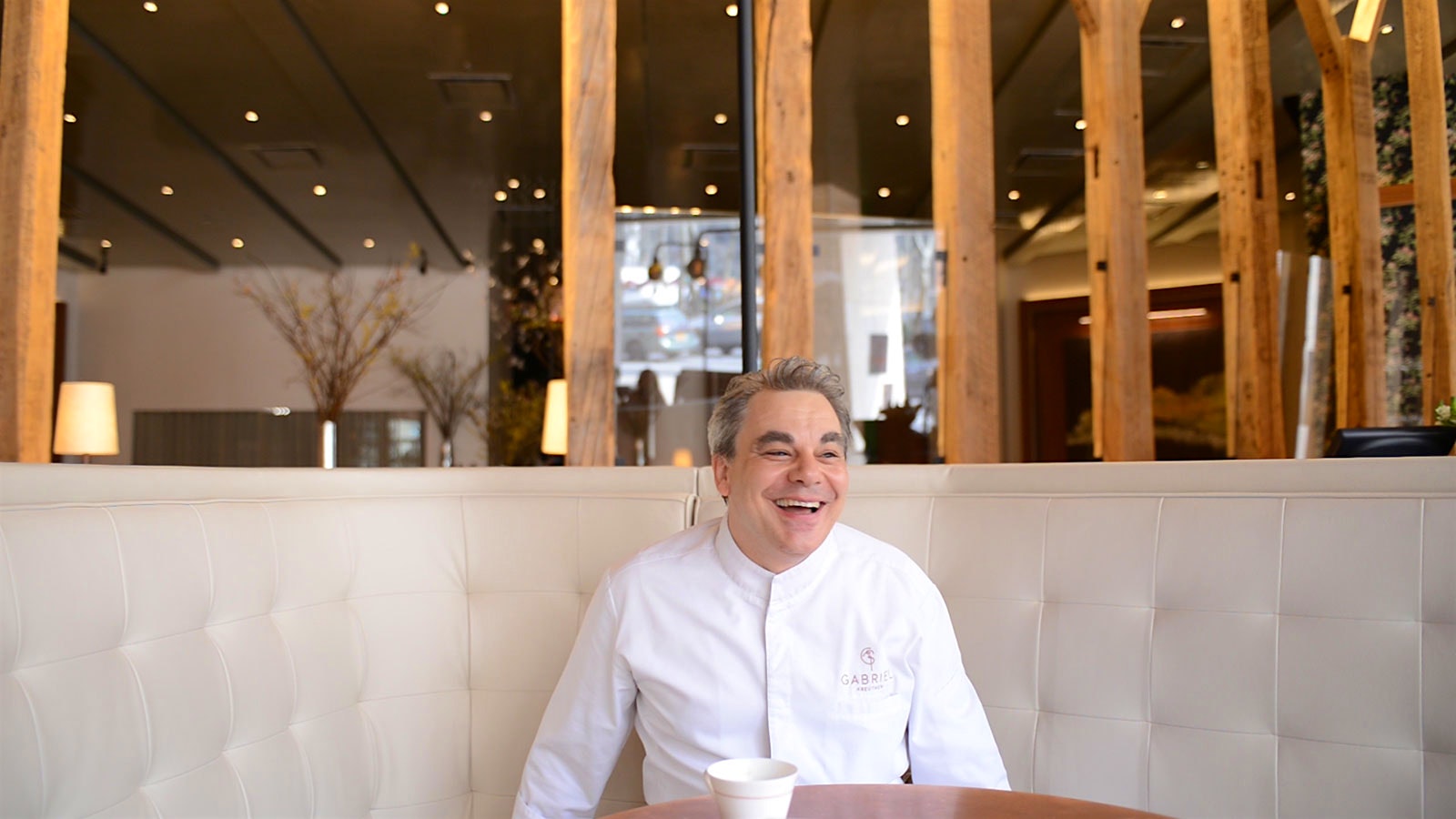 Chef Gabriel Kreuther in a booth at his New York restaurant